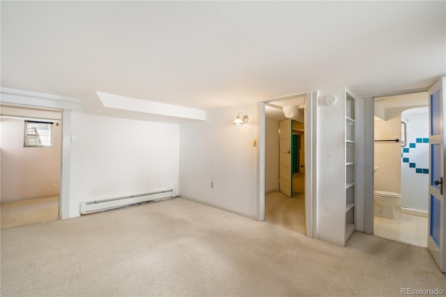 basement with light carpet and a baseboard heating unit