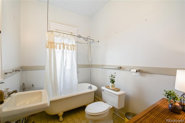 full bathroom featuring toilet, shower / tub combo with curtain, sink, and tile patterned flooring