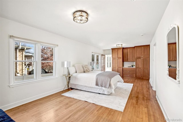 bedroom with light wood-style floors and baseboards