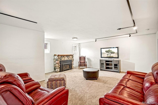 carpeted living room featuring rail lighting and a fireplace