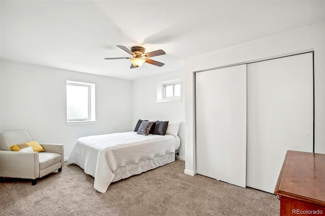 bedroom featuring a closet, light carpet, and ceiling fan