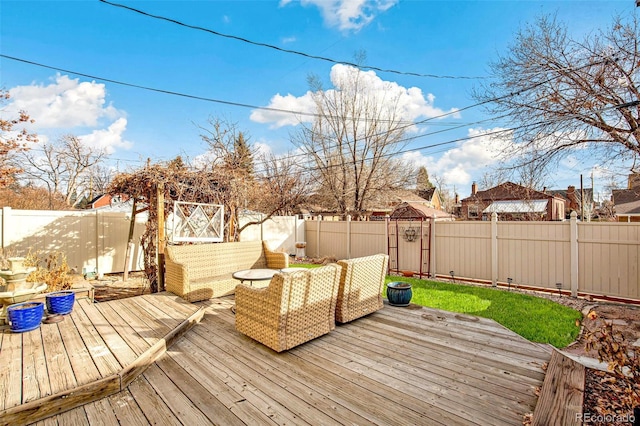 wooden deck featuring a fenced backyard and outdoor lounge area