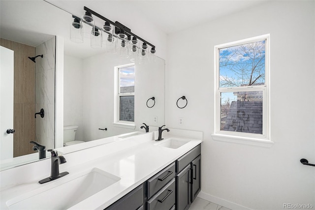 full bathroom featuring marble finish floor, a sink, and toilet