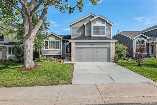 5068 E Crestone Ave, Castle Rock, CO 80104 - view of front of property with brick siding, driveway, a front yard, and an attached garage