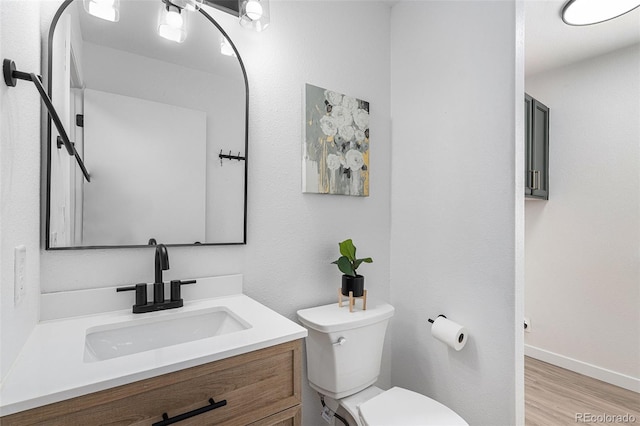 5068 E Crestone Ave, Castle Rock, CO 80104 - half bathroom featuring toilet, vanity, wood finished floors, and baseboards