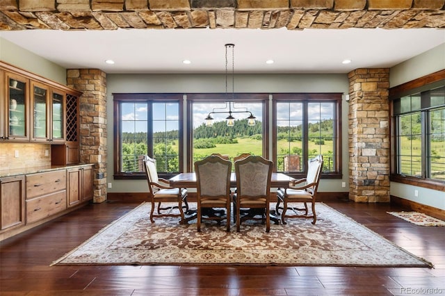 dining area featuring a wealth of natural light, recessed lighting, dark wood-type flooring, and baseboards