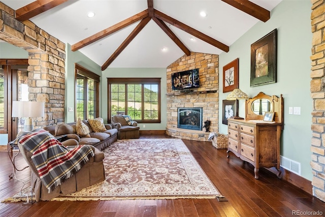 2480 Castle Butte Dr, Castle Rock, CO 80109 - living area featuring visible vents, vaulted ceiling with beams, baseboards, hardwood / wood-style floors, and a stone fireplace
