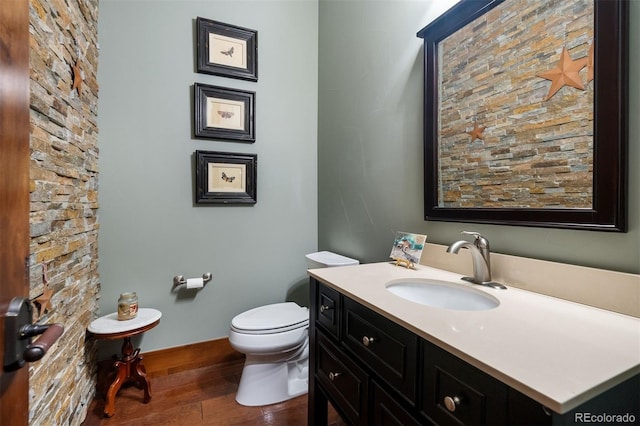 2480 Castle Butte Dr, Castle Rock, CO 80109 - bathroom with baseboards, toilet, wood finished floors, and vanity