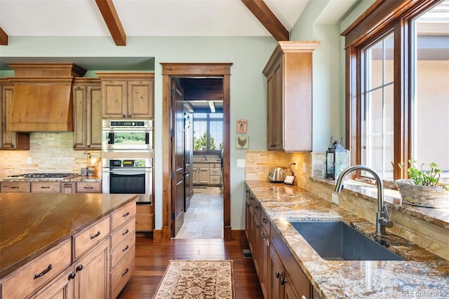 2480 Castle Butte Dr, Castle Rock, CO 80109 - kitchen featuring range hood, dark wood-style flooring, a sink, appliances with stainless steel finishes, and beamed ceiling