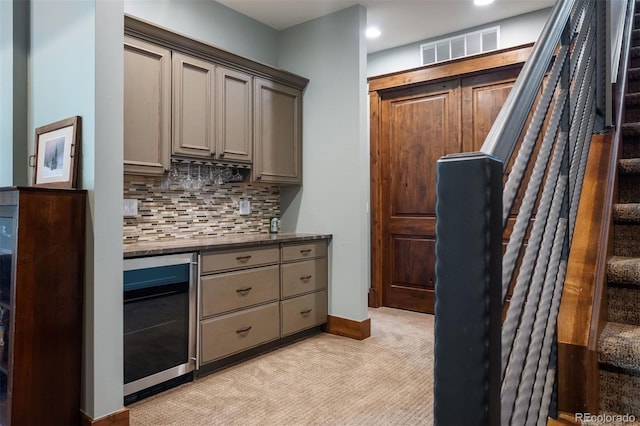 2480 Castle Butte Dr, Castle Rock, CO 80109 - kitchen with visible vents, gray cabinetry, beverage cooler, light colored carpet, and decorative backsplash