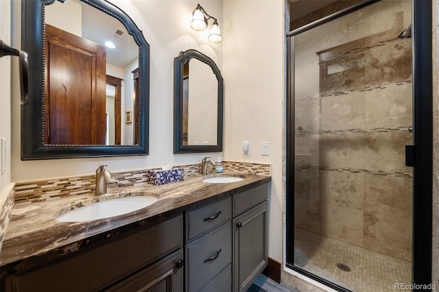 2480 Castle Butte Dr, Castle Rock, CO 80109 - full bathroom featuring double vanity, visible vents, a stall shower, and a sink