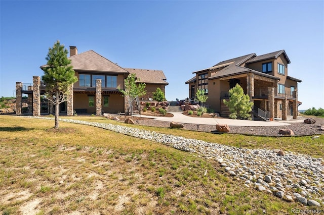 2480 Castle Butte Dr, Castle Rock, CO 80109 - exterior space with stucco siding, a yard, a chimney, and stairs