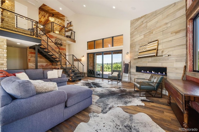 2480 Castle Butte Dr, Castle Rock, CO 80109 - living area with wood finished floors, high vaulted ceiling, recessed lighting, a fireplace, and stairs
