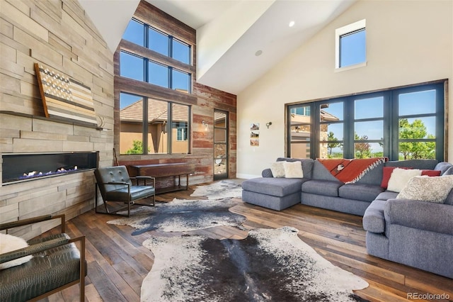 2480 Castle Butte Dr, Castle Rock, CO 80109 - living area featuring plenty of natural light, a fireplace, wood-type flooring, and high vaulted ceiling