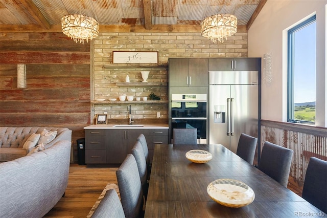 2480 Castle Butte Dr, Castle Rock, CO 80109 - dining space with beam ceiling, wood finished floors, wooden walls, wooden ceiling, and a chandelier