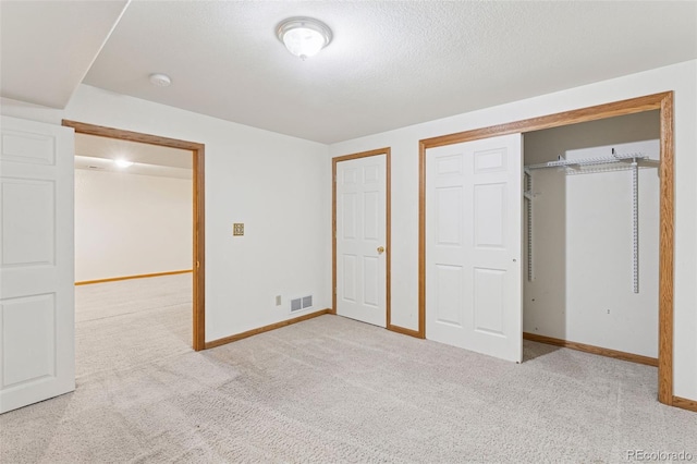 unfurnished bedroom featuring a closet, carpet flooring, visible vents, and baseboards