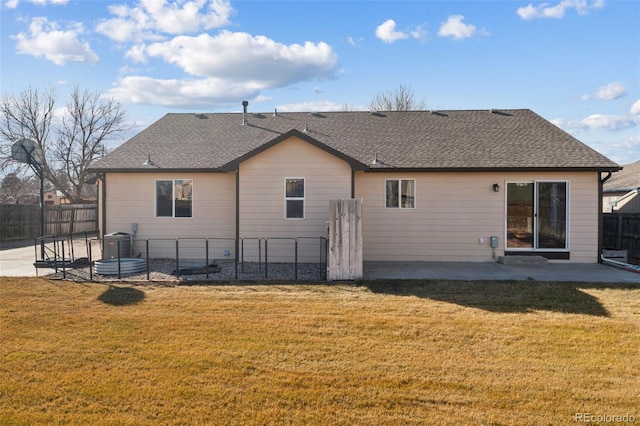 rear view of house featuring a patio area, a lawn, and fence