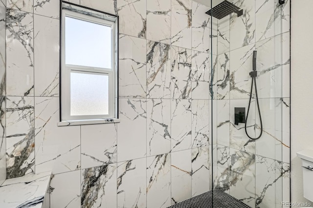 full bath with a tile shower