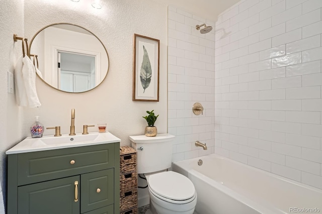 full bath featuring vanity, shower / bathing tub combination, toilet, and a textured wall