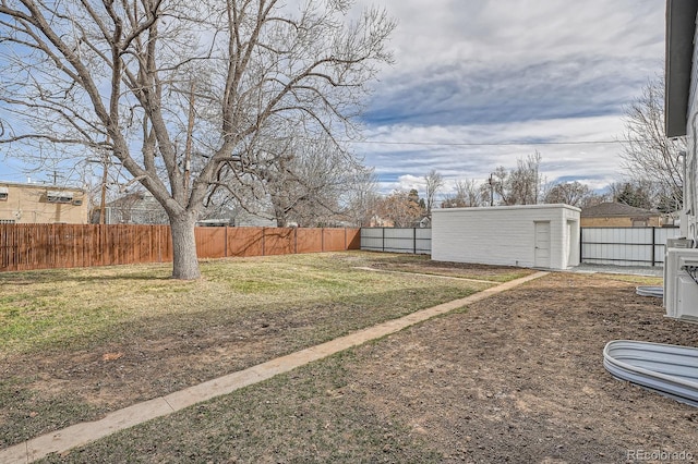 view of yard with an outdoor structure, a storage shed, and a fenced backyard