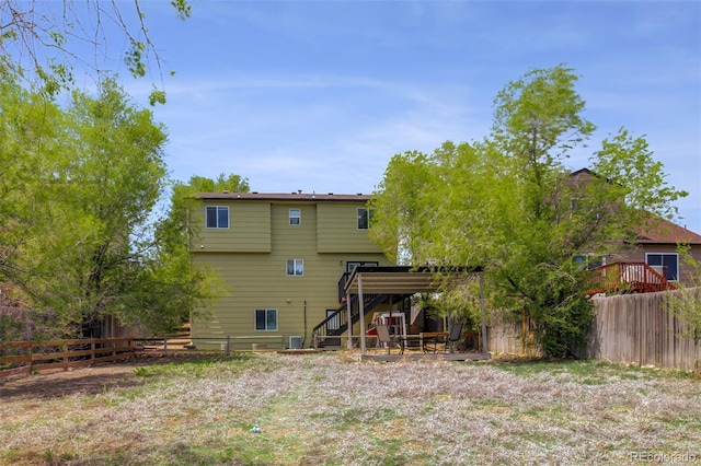 1156 White Stone Way, Fountain, CO 80817 - back of property with stairs, a fenced backyard, and a wooden deck