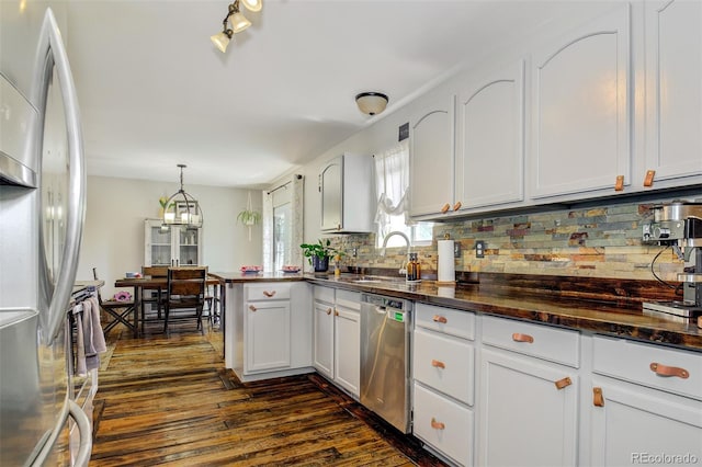 1156 White Stone Way, Fountain, CO 80817 - kitchen with appliances with stainless steel finishes, a sink, dark wood finished floors, backsplash, and white cabinetry