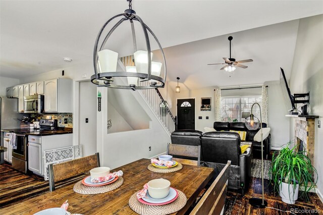 1156 White Stone Way, Fountain, CO 80817 - dining space with stairs, ceiling fan, vaulted ceiling, and dark wood finished floors