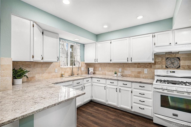 13118 Ash St, Thornton, CO 80241 - kitchen featuring white gas range, under cabinet range hood, white cabinets, light stone countertops, and tasteful backsplash
