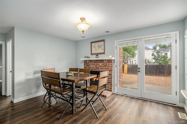 13118 Ash St, Thornton, CO 80241 - dining area with wood finished floors and a brick fireplace
