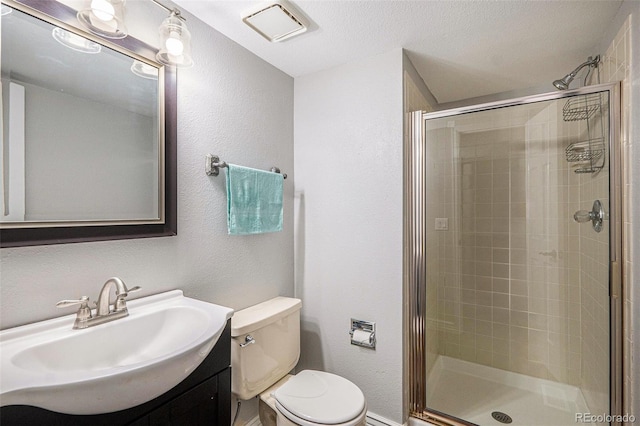 13118 Ash St, Thornton, CO 80241 - full bathroom with a shower stall, vanity, a textured wall, and a textured ceiling