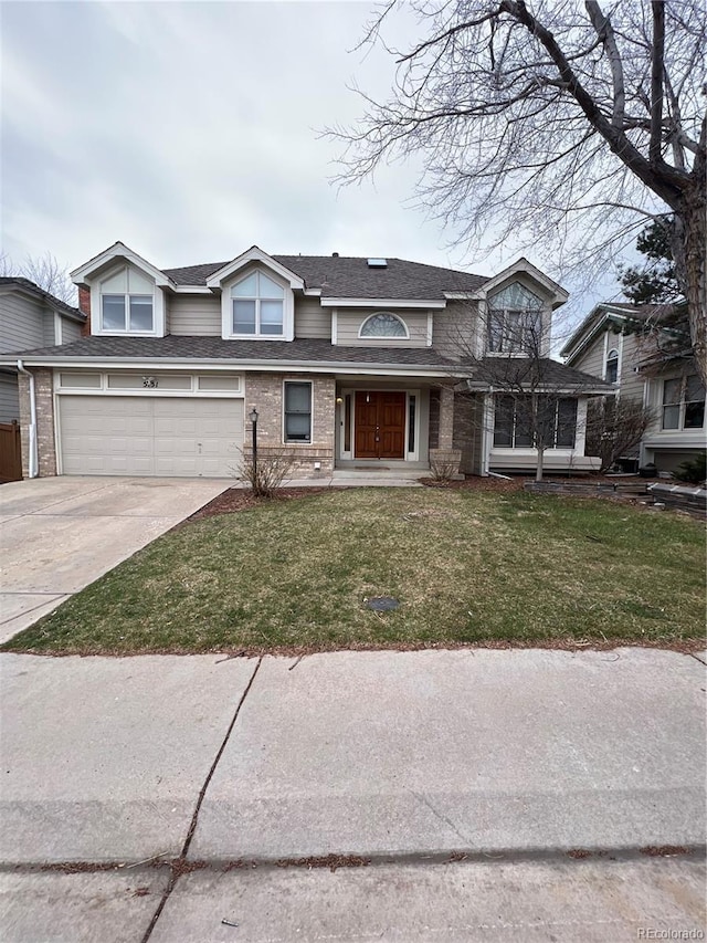 view of front of house featuring concrete driveway, a front lawn, an attached garage, brick siding, and a shingled roof