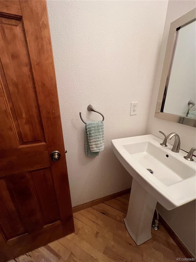 bathroom featuring baseboards and wood finished floors