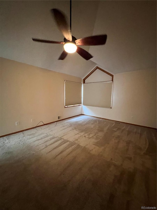 additional living space with carpet, baseboards, vaulted ceiling, and ceiling fan
