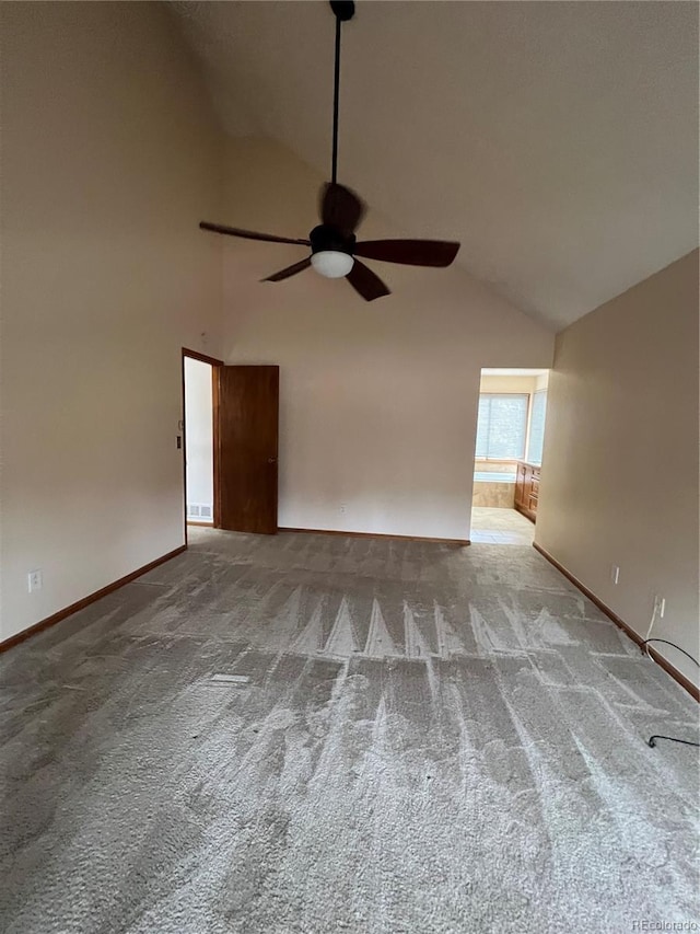 unfurnished room with ceiling fan, high vaulted ceiling, carpet, and baseboards