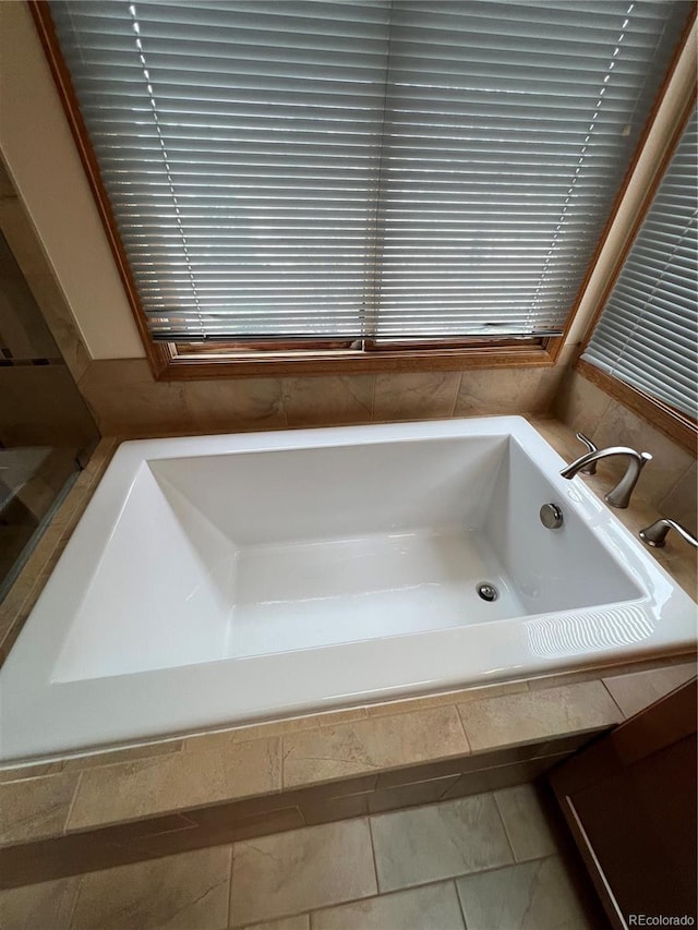 full bathroom featuring a bath and a wealth of natural light