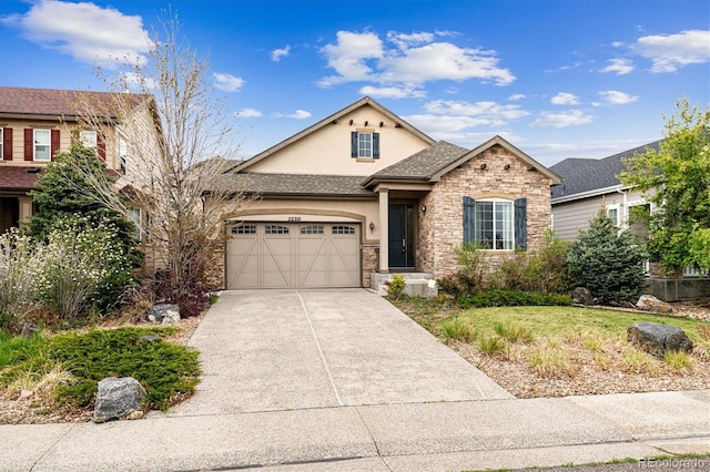 22310 E Chenango Dr, Aurora, CO 80015 - view of front facade with stucco siding, stone siding, an attached garage, driveway, and a front yard