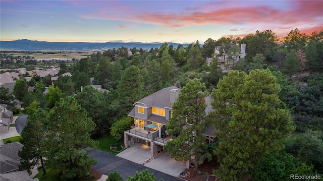 aerial view at dusk featuring a mountain view