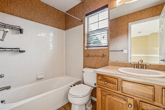 bathroom with toilet, shower / bathing tub combination, vanity, and tile patterned floors