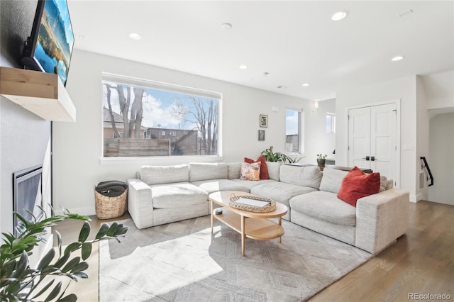 living area with wood finished floors and recessed lighting