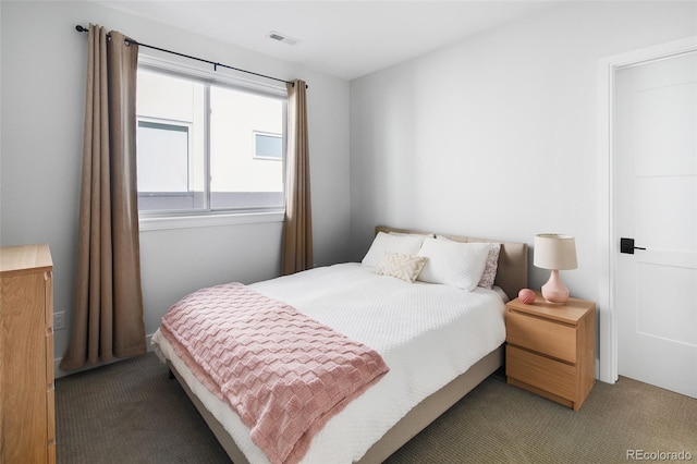 carpeted bedroom featuring visible vents