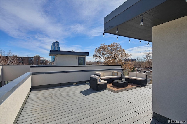 wooden terrace with an outdoor hangout area and a view of city