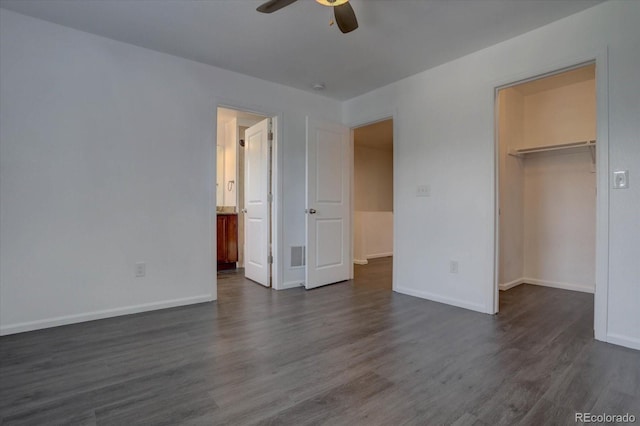 9520 Halstead, Lone Tree, CO 80124 - unfurnished bedroom with dark wood-style floors, a walk in closet, baseboards, and a closet