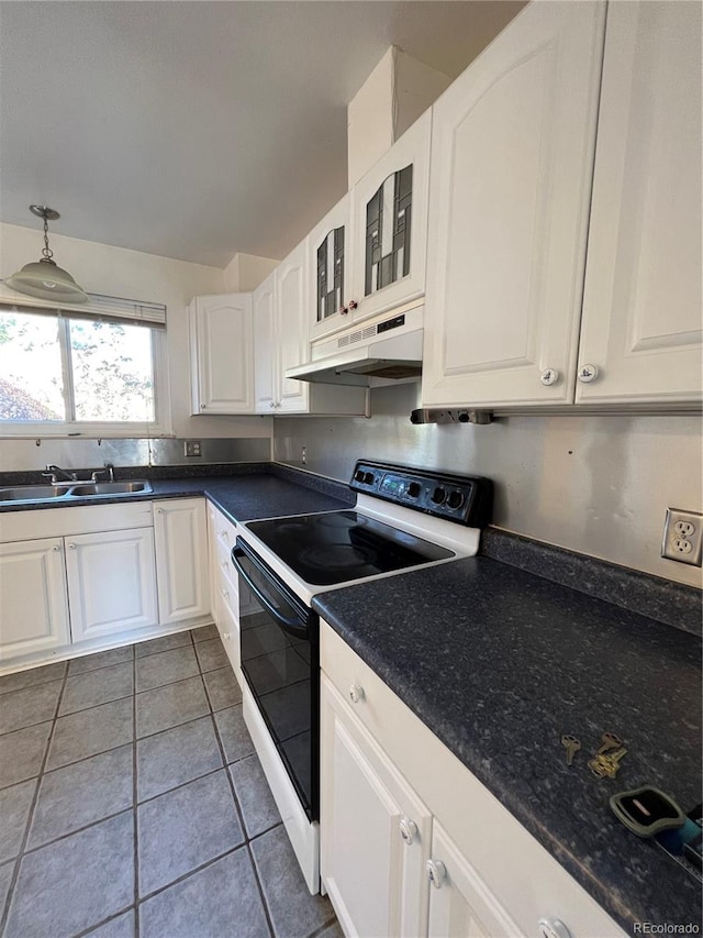 kitchen with dark tile patterned flooring, white electric range, sink, pendant lighting, and white cabinets