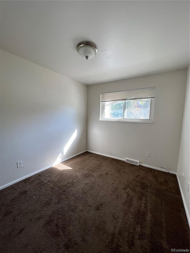 empty room with dark carpet