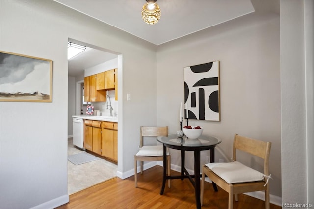 dining room featuring sink and light hardwood / wood-style floors