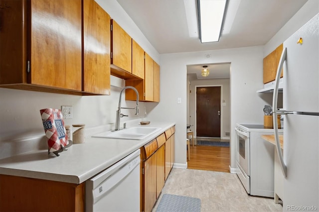 kitchen featuring sink and white appliances