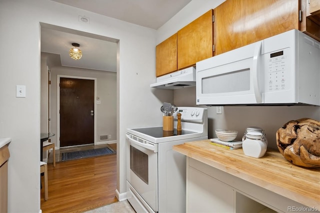 kitchen featuring wood counters, white appliances, and light hardwood / wood-style floors