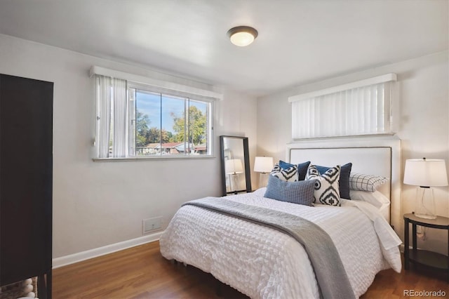 bedroom with dark hardwood / wood-style flooring