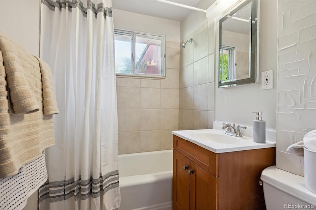 full bathroom featuring vanity, shower / tub combo, and toilet