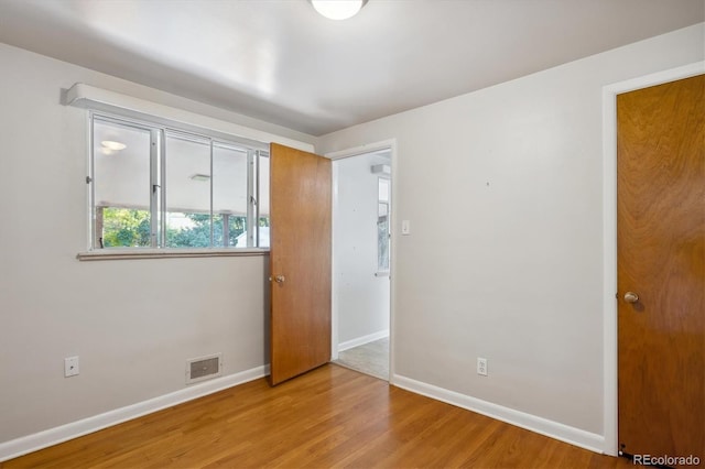 unfurnished bedroom with wood-type flooring